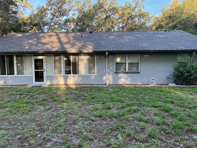 3365 S Crossbill Loop, Inverness, FL 34450 - view of front of house with a front lawn, stucco siding, and roof with shingles