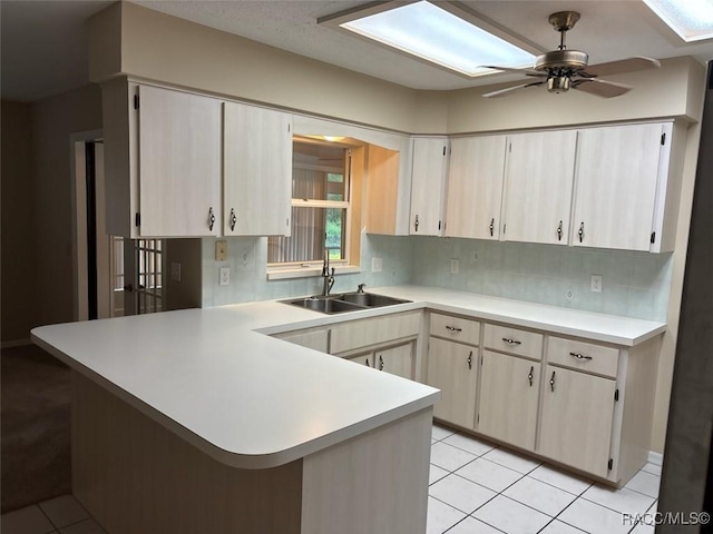 3365 S Crossbill Loop, Inverness, FL 34450 - kitchen featuring a peninsula, light countertops, tasteful backsplash, and light tile patterned flooring