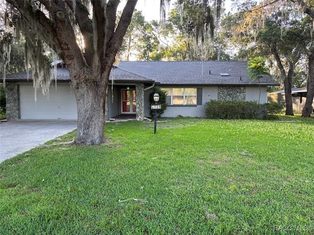3365 S Crossbill Loop, Inverness, FL 34450 - ranch-style house with concrete driveway, an attached garage, a front lawn, a shingled roof, and french doors