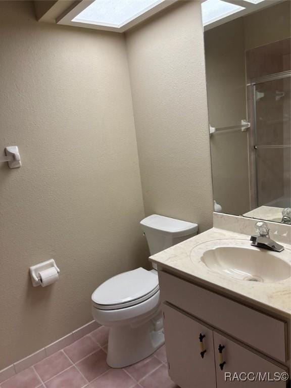 3365 S Crossbill Loop, Inverness, FL 34450 - full bathroom featuring vanity, a skylight, tile patterned floors, and an enclosed shower