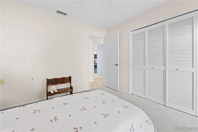 unfurnished bedroom featuring light colored carpet and a closet