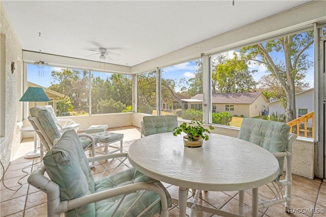 sunroom featuring ceiling fan