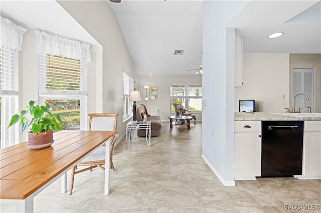 kitchen featuring lofted ceiling, sink, white cabinetry, black dishwasher, and ceiling fan