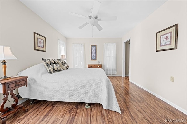 bedroom with hardwood / wood-style floors and ceiling fan