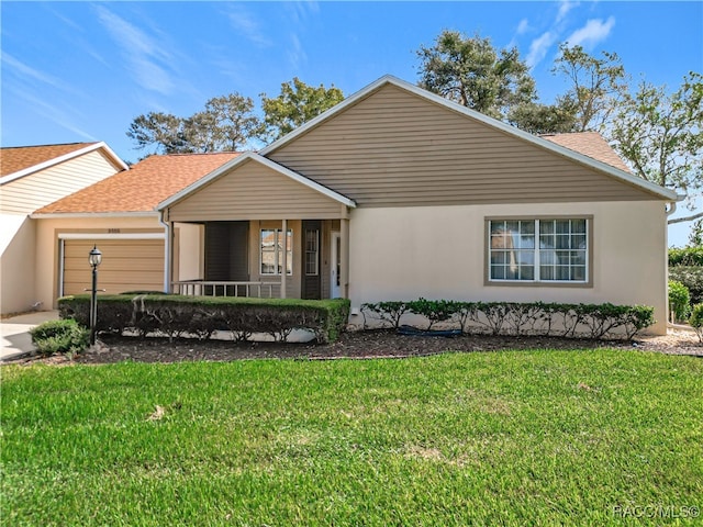 single story home featuring a porch, a front yard, and a garage