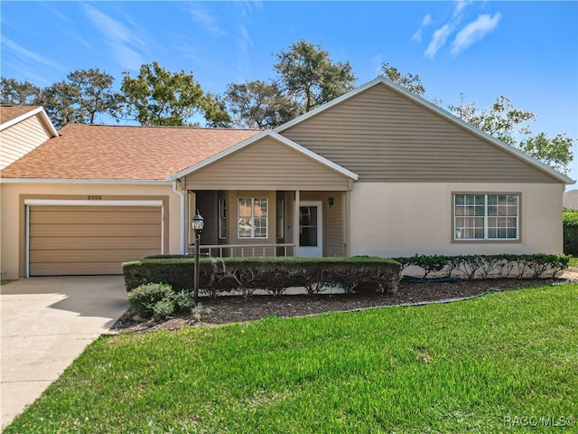 ranch-style house featuring a porch, a garage, and a front lawn