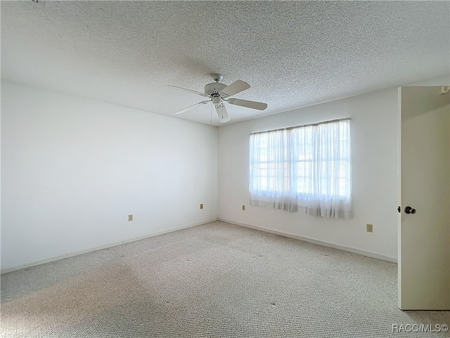 carpeted empty room featuring a textured ceiling and ceiling fan