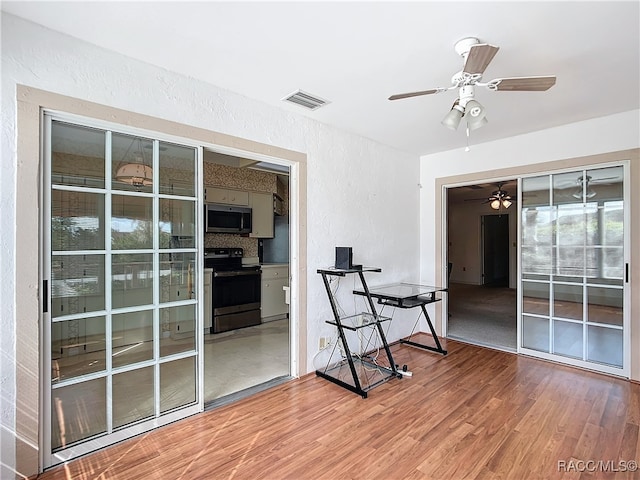 interior space featuring hardwood / wood-style floors and ceiling fan