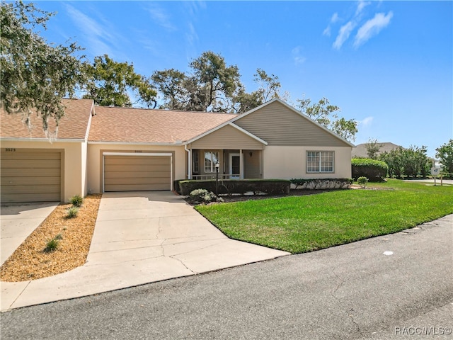 single story home with a garage and a front lawn