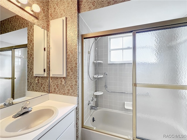 bathroom featuring vanity and enclosed tub / shower combo