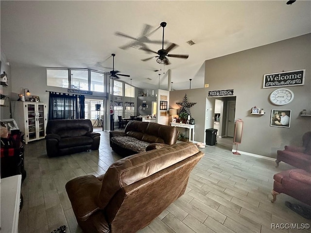 living room featuring high vaulted ceiling and ceiling fan