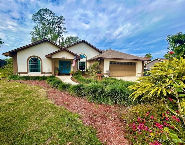 view of front facade with a front yard and a garage