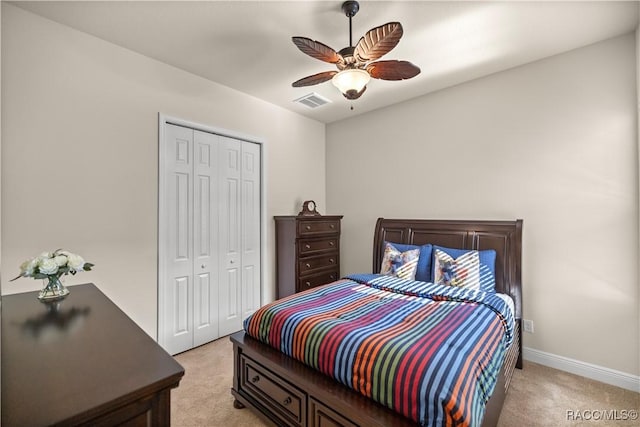 bedroom featuring light carpet, a closet, and ceiling fan