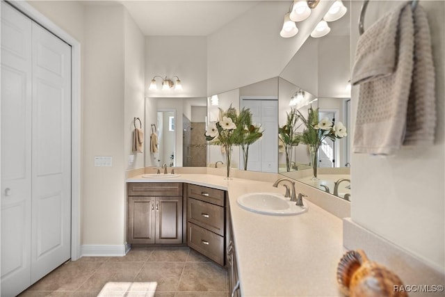 bathroom with tile patterned floors, vanity, and walk in shower