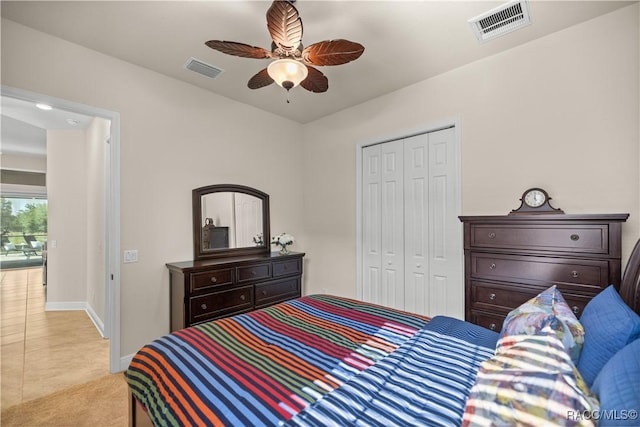 bedroom featuring ceiling fan, light tile patterned floors, and a closet