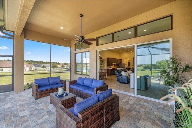 sunroom featuring ceiling fan and a healthy amount of sunlight