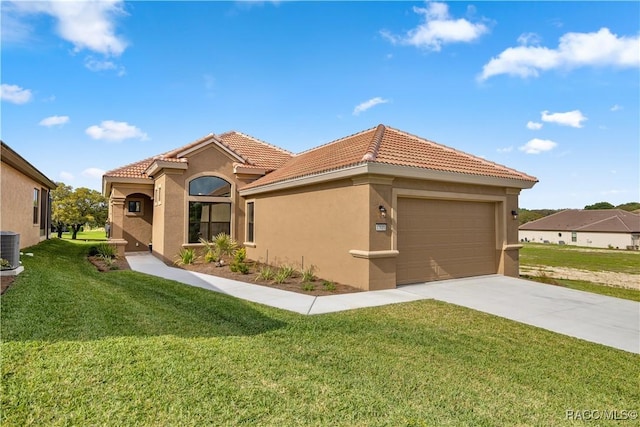 mediterranean / spanish-style house with a front lawn and a garage