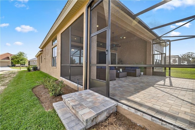 rear view of property with an outdoor hangout area, a lanai, ceiling fan, a patio area, and a yard