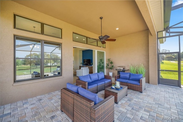 view of patio featuring an outdoor living space, ceiling fan, and a lanai