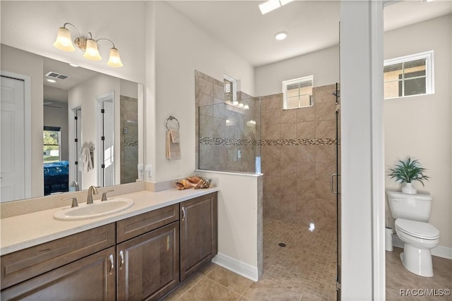 bathroom with tiled shower, tile patterned floors, plenty of natural light, and toilet