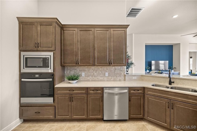 kitchen with ceiling fan, sink, light tile patterned flooring, and appliances with stainless steel finishes