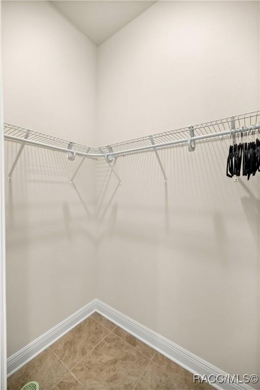 spacious closet featuring tile patterned floors