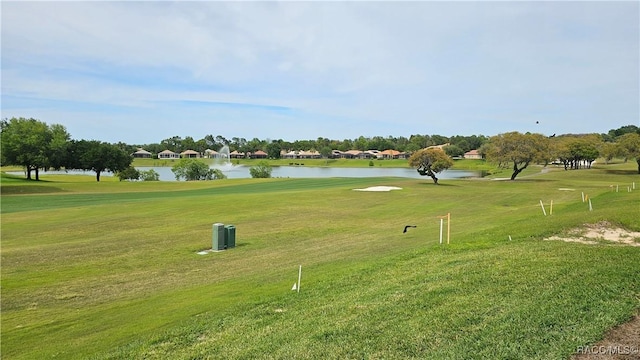 view of home's community with a yard and a water view