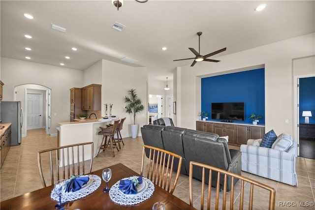 dining space featuring ceiling fan and light tile patterned flooring