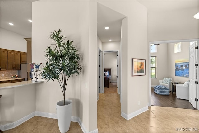 hall featuring light tile patterned floors