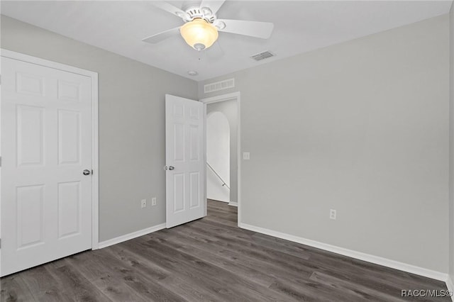 unfurnished bedroom with ceiling fan and dark hardwood / wood-style floors