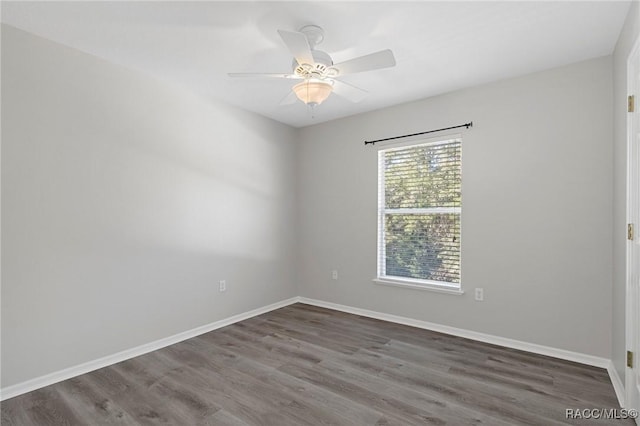 spare room with ceiling fan and dark hardwood / wood-style flooring