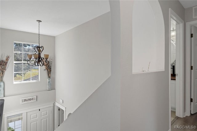 interior space featuring wood-type flooring and a notable chandelier