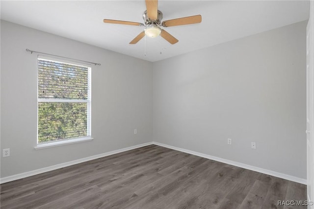 empty room featuring dark hardwood / wood-style flooring and ceiling fan