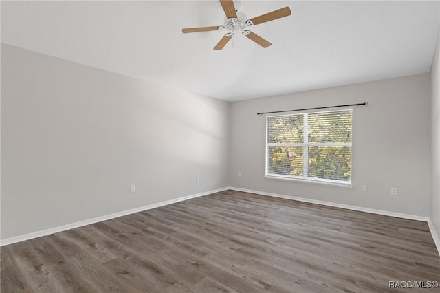 unfurnished room with dark hardwood / wood-style flooring