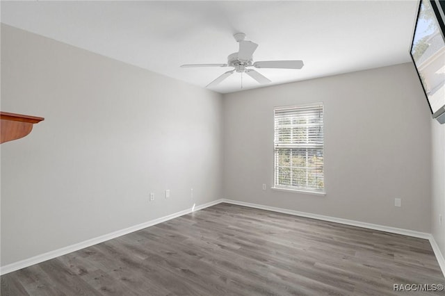 unfurnished room with ceiling fan and wood-type flooring