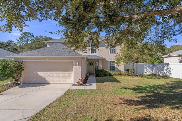 view of front of property featuring a garage and a front lawn