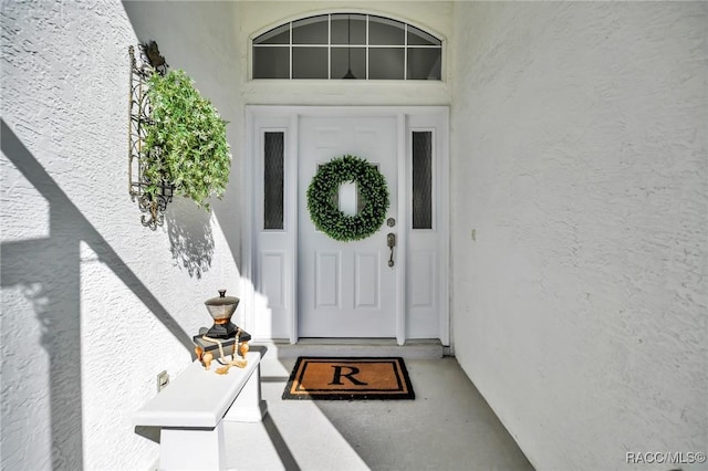 doorway to property with stucco siding