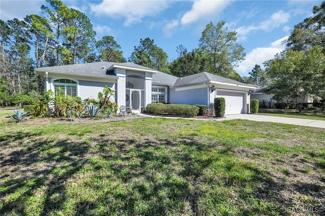 view of front facade with stucco siding, driveway, an attached garage, and a front lawn