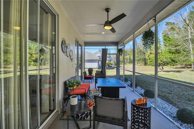 sunroom / solarium featuring ceiling fan