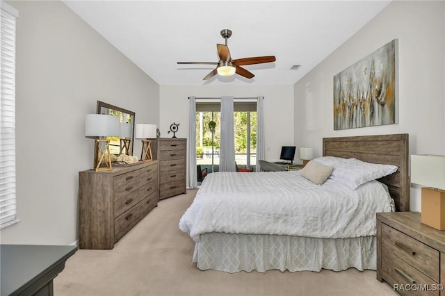 bedroom featuring visible vents, light colored carpet, a ceiling fan, and access to outside