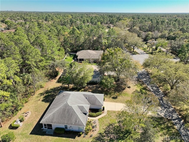 drone / aerial view featuring a view of trees