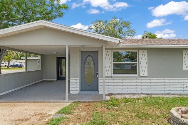 1 Taft St, Beverly Hills, FL 34465 - view of front of property featuring an attached carport and stucco siding