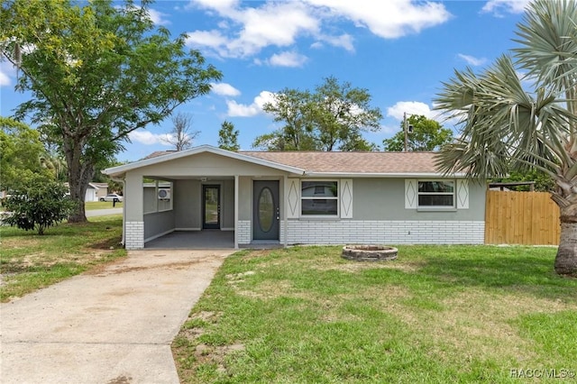 1 Taft St, Beverly Hills, FL 34465 - single story home with concrete driveway, brick siding, an attached carport, and roof with shingles