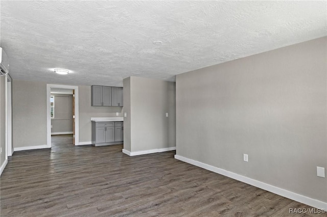 1 Taft St, Beverly Hills, FL 34465 - unfurnished living room featuring baseboards, dark wood-type flooring, and a textured ceiling