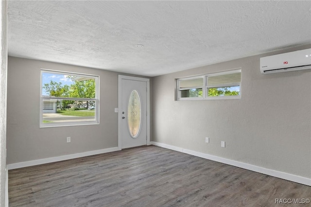 1 Taft St, Beverly Hills, FL 34465 - entryway with an AC wall unit, a textured ceiling, wood finished floors, and baseboards