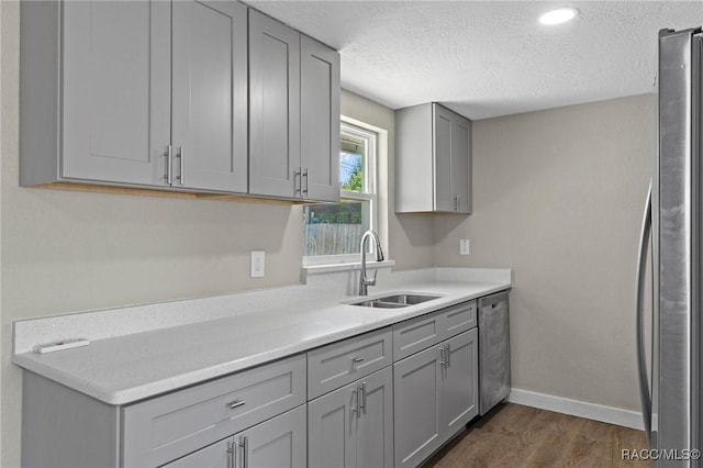 1 Taft St, Beverly Hills, FL 34465 - kitchen featuring gray cabinetry, a sink, appliances with stainless steel finishes, dark wood finished floors, and baseboards