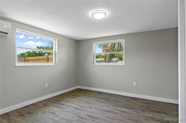 1 Taft St, Beverly Hills, FL 34465 - unfurnished room with a wall unit AC, wood finished floors, baseboards, and a textured ceiling