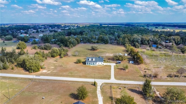 birds eye view of property with a rural view