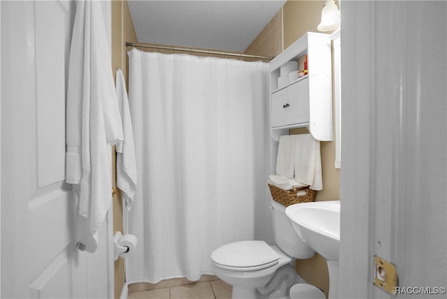 bathroom featuring tile patterned flooring, sink, and toilet