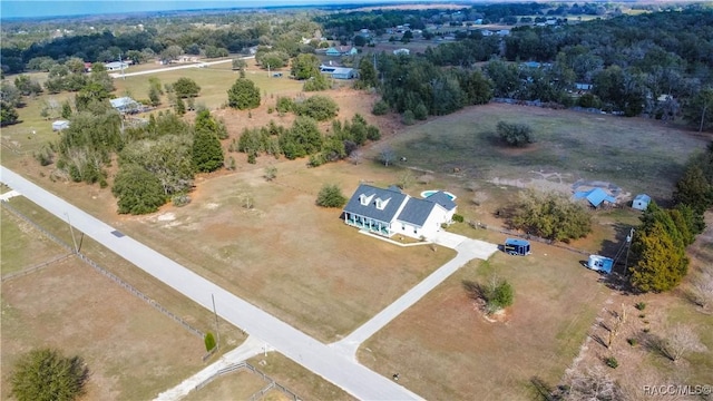 birds eye view of property featuring a rural view